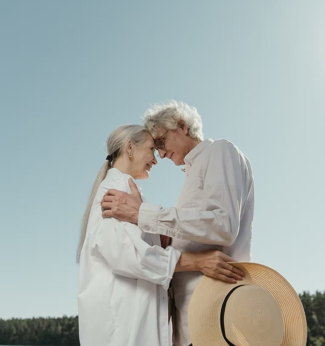 Elder couple holding each other and smiling
